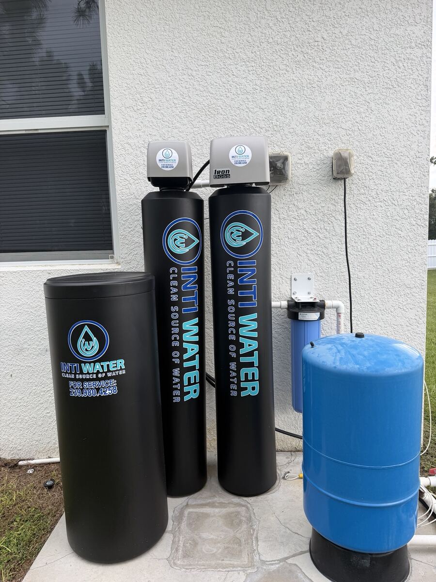 Iron and sulfur treatment tanks installed on a concrete pad