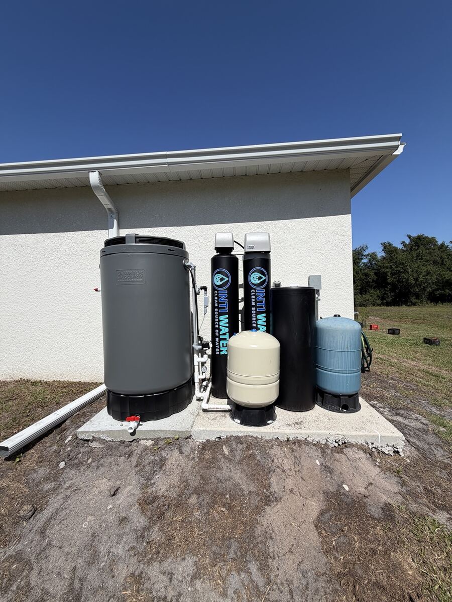 Whole-home well water treatment system installed outside a Florida house